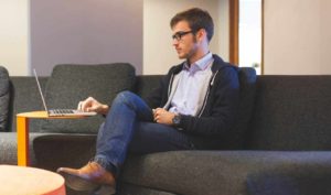 Plastic Surgeon Orange County Patient Sitting on Laptop